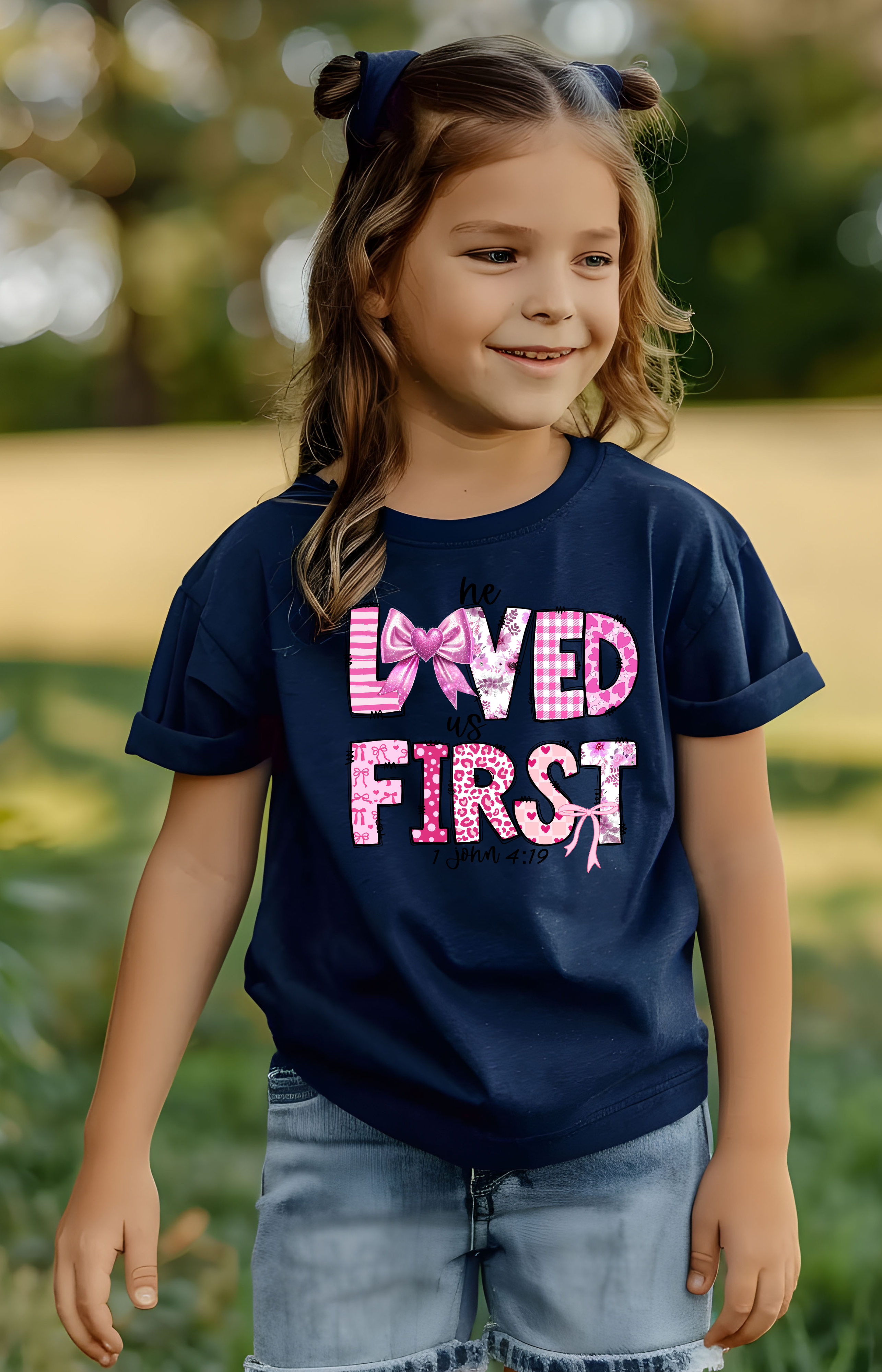 He Loved Us First Kids’ Tee – 1 John 4:19 Faith Shirt
