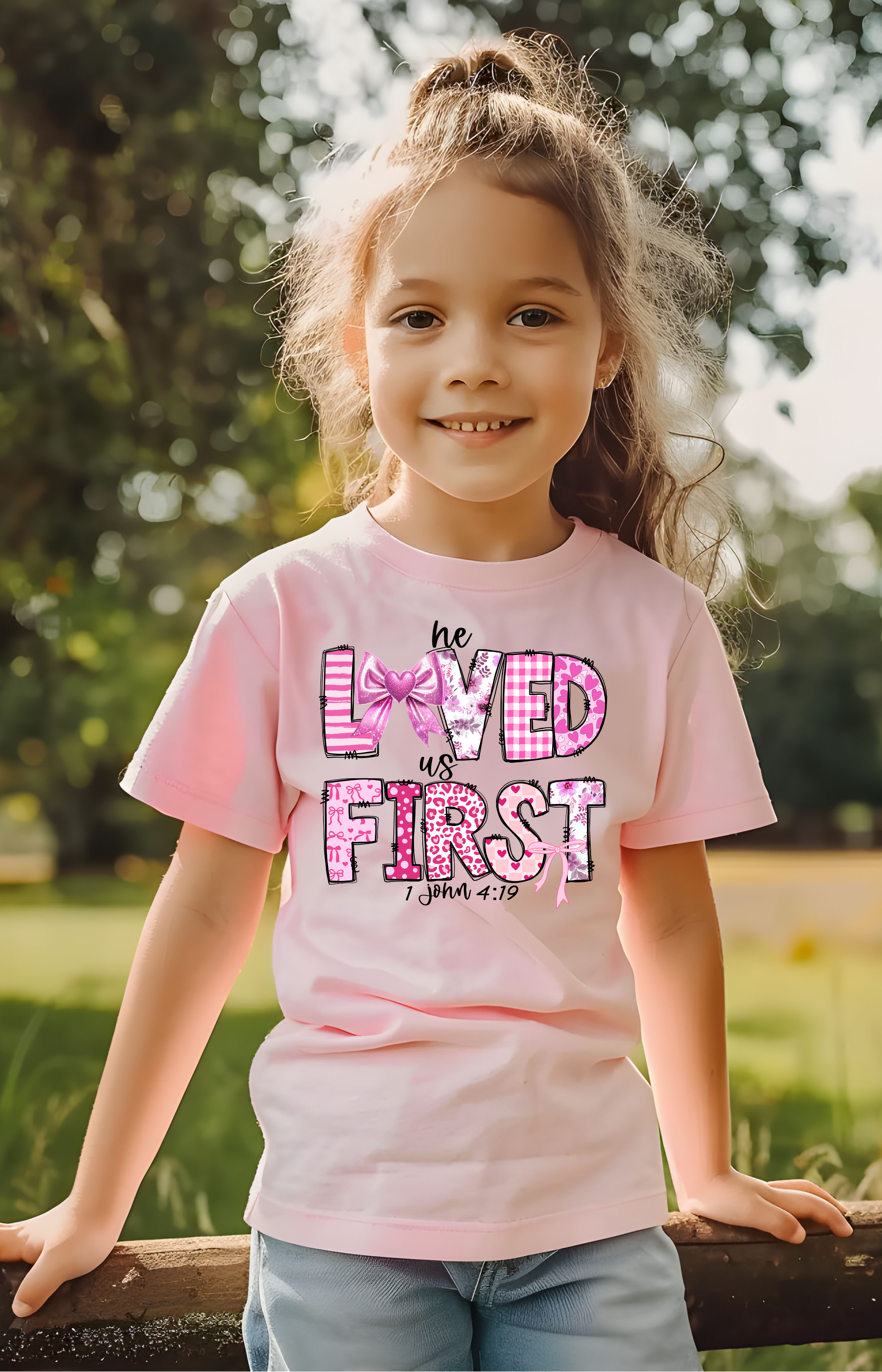 He Loved Us First Kids’ Tee – 1 John 4:19 Faith Shirt